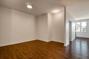 Chicago apartment for rent - an empty living room with wood floors and white walls