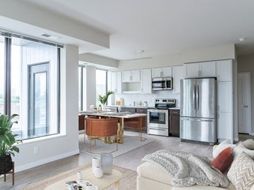Minneapolis apartment for rent - a kitchen and living room with stainless steel appliances and a wooden table