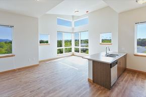 Bellingham apartment for rent - an empty living room with a kitchen and a large window