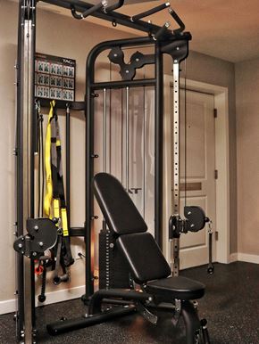 Seattle apartment for rent - A black home gym setup with a squat rack, bench, and weights.