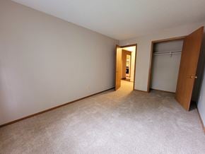 Eagan apartment for rent - an empty bedroom with a closet and a door to a bathroom