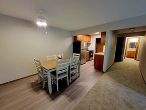 Eagan apartment for rent - a dining room with a table and chairs and a kitchen
