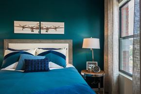 Phoenix apartment for rent - Bedroom With Bed And Side Table With Large Window At Union at Roosevelt Apartments In Phoenix, AZ