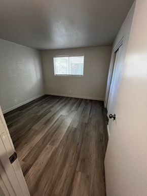 Tucson apartment for rent - A room with wooden flooring and a window.