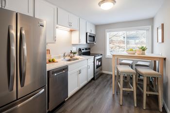 Modern kitchen with stainless steel appliances and granite counter tops
