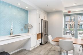 South Boston apartment for rent - 50 WB community space with a kitchen and dining area with a table and chairs
