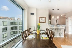 South Boston apartment for rent - 50 WB's furnished apartment showing a dining room with a large window and a table with chairs