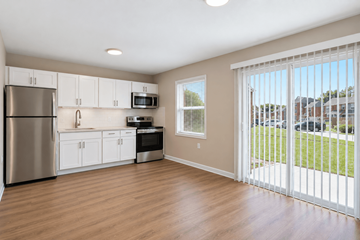 Indianapolis apartment for rent - A kitchen with white cabinets and a stainless steel refrigerator.