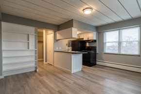 Indianapolis apartment for rent - a kitchen with a island and a black stove and a refrigerator