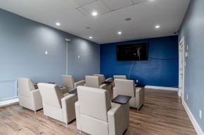 Indianapolis apartment for rent - a cinema room with blue walls and white chairs