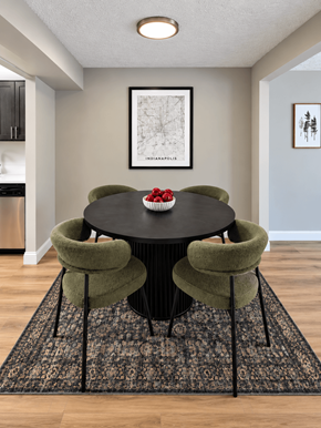 Indianapolis apartment for rent - A dining room with a black table and green chairs.