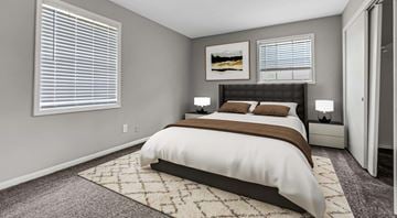 Augusta apartment for rent - A bedroom with a large bed and a rug on the floor.