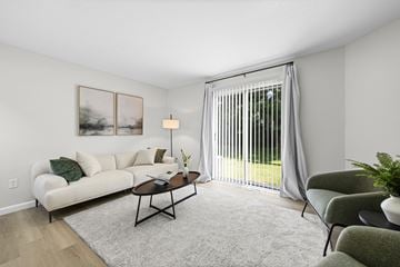 Toledo apartment for rent - A living room with a white couch, a coffee table, and a painting on the wall.