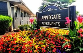 Columbus apartment for rent - a sign in front of a garden of flowers