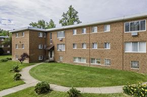 Cleveland apartment for rent - a large brick building with a green lawn in front of it