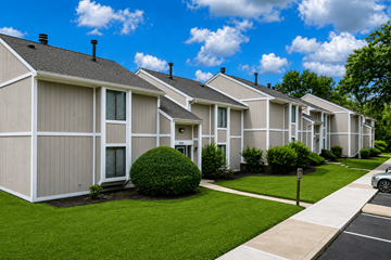 Indianapolis townhouse for rent - A row of houses with a car parked on the street.