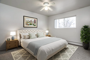 Westland apartment for rent - A bedroom with a large bed, a ceiling fan, and a potted plant.