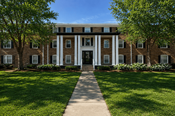 Indianapoils apartment for rent - A building with a white front door flanked by two trees.