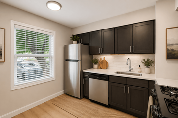 Indianapoils apartment for rent - A kitchen with black cabinets and a stainless steel refrigerator.