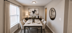 Indianapolis apartment for rent - A dining room with a table set for two and a large mirror on the wall.