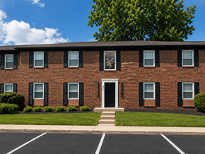 Indianapolis apartment for rent - A red brick building with a white door and windows.
