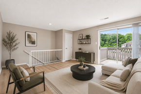 Indianapolis apartment for rent - A living room with a white couch, a coffee table, and a tree.