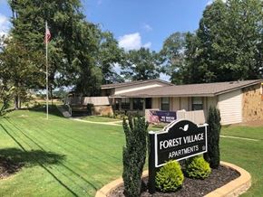 Macon apartment for rent - a house with a forest village apartments sign