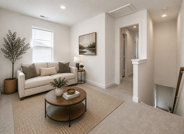Lebanon apartment for rent - A living room with a white couch, a tree, a coffee table, and a painting on the wall.