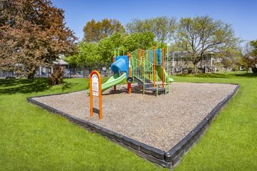 Indianapolis townhouse for rent - A playground with a slide and a climbing frame.