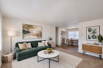 Indianapolis apartment for rent - A living room with a green couch and a painting on the wall.
