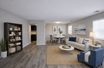 Indianapolis apartment for rent - A living room with a white couch, a coffee table, and a large painting on the wall.