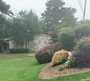 Acworth apartment for rent - a yard with a house and some bushes and trees