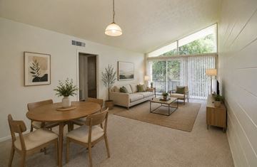 Jacksonville apartment for rent - A living room with a dining table and chairs.
