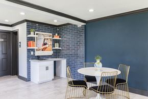 Orlando apartment for rent - a dining room with blue walls and a white table and chairs