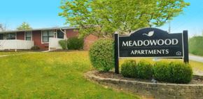 Franklin apartment for rent - a sign for the meadowwood apartments in front of a brick building