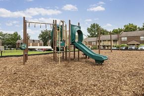 New Albany apartment for rent - a playground with a slide and monkey bars in a park