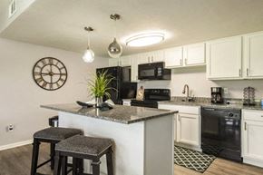 New Albany apartment for rent - a kitchen with a counter top with two stools