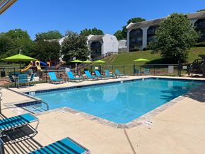 Homewood apartment for rent - A large swimming pool with a slide and sun loungers.
