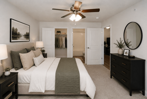 Columbus apartment for rent - A bedroom with a large bed and a ceiling fan.