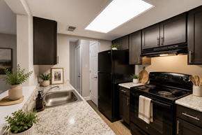 Indianapolis apartment for rent - A kitchen with black appliances and brown cabinets.