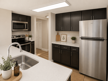 Indianapolis apartment for rent - A kitchen with a white counter top and a stainless steel refrigerator.