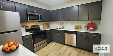 Indianapolis apartment for rent - A kitchen with black cabinets and stainless steel appliances.