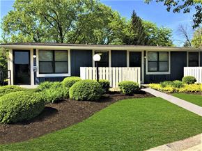 Dayton apartment for rent - A house with a well-manicured lawn and a white lamp post.