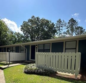 Dayton apartment for rent - A white picket fence in front of a building.
