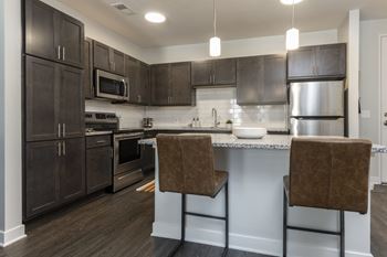 Kitchen with dark brown cabinets