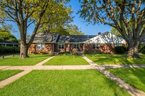 Indianapolis triplex for rent - a red brick house with trees in front of it