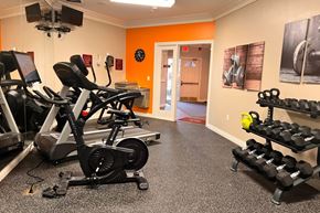 Brownstown apartment for rent - A gym with orange walls and a variety of exercise equipment.