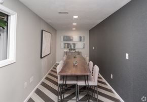 Columbus apartment for rent - a dining room with a long wooden table and white chairs