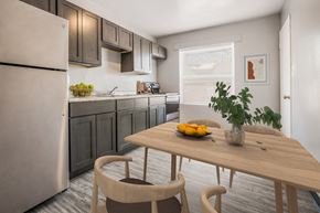 Indianapolis triplex for rent - a kitchen with stainless steel appliances and a table with fruit
