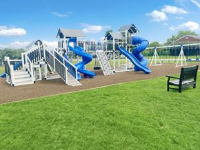 Indianapolis apartment for rent - a playground with slides and a playset with benches